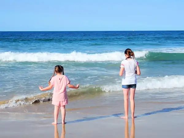 Kiwis relaxing on the beach in Gold Coast QLD — Relocating for a relaxed lifestyle
