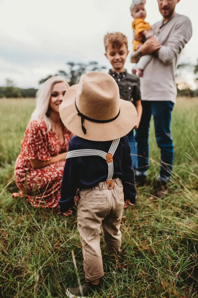 Kiwi mother hugging children outdoors in Australia